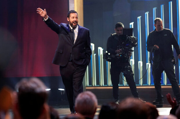 Actor and comedian Adam Sandler waves as he is awarded the Mark Twain Prize for American Humor at the Kennedy Center in Washington, U.S., March 19, 2023. REUTERS/Joshua Roberts