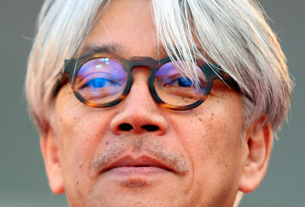 FILE PHOTO: Ryuichi Sakamoto, jury member and Japanese musician, looks on as he arrives on the red carpet for the premiere of "Gravity" by director Alfonso Cuaron at the 70th Venice Film Festival in Venice August 28, 2013. REUTERS/Alessandro Bianchi/File Photo