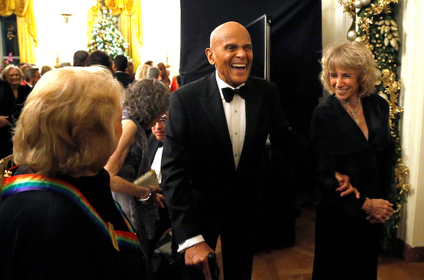 Harrry Belafonte laughs with a fellow audience member as they depart after a reception in Washington. STORY: Harry Belafonte, who mixed music, acting, and activism, dies at 96