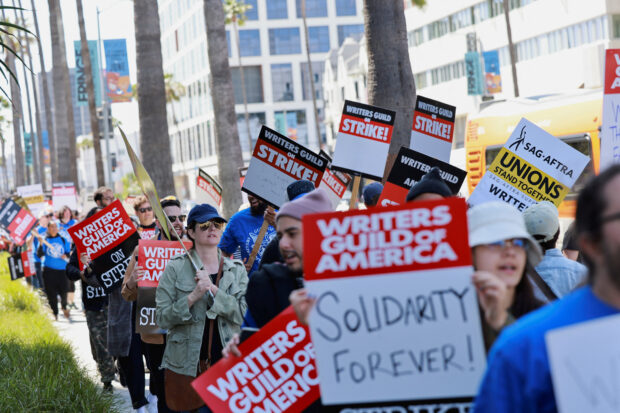 Workers and supporters of the Writers Guild of America protest outside the Netflix offices after union negotiators called a strike for film and television writers in Los Angeles, California, U.S., May 2, 2023. REUTERS/Aude Guerrucci
