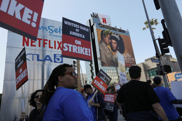 Workers and supporters of the Writers Guild of America protest outside the Netflix offices at Sunset Bronson Studios after union negotiators called a strike for film and television writers in Los Angeles, California, U.S., May 2, 2023. REUTERS/Aude Guerrucci