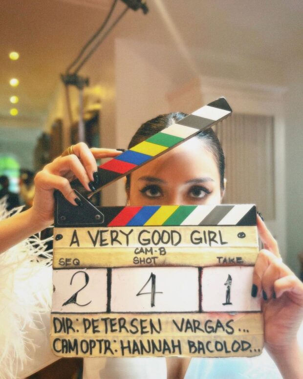 Kathryn Bernardo holding a clapperboard for movie "A Very Good Girl"