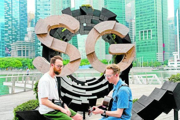 Honne’s Andy Clutterbuck (left) and James Hatcher performing by the Here is SG sculpture in Marina Bay.