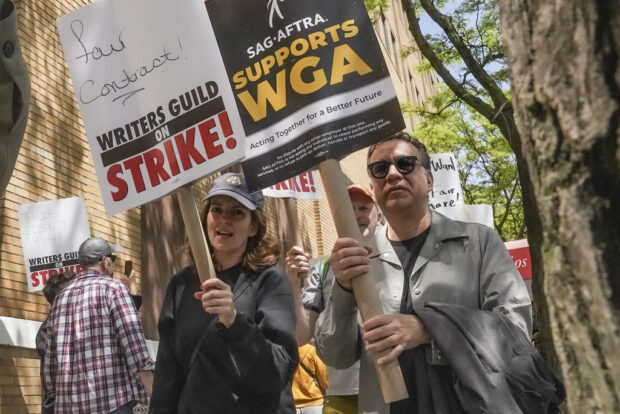 FILE - Actors and comedians Tina Fey, center, and Fred Armisen, right, join striking members of the Writers Guild of America on the picket line during a rally outside Silvercup Studios, Tuesday May 9, 2023, in New York. Unionized Hollywood actors on the verge of a strike have agreed to allow a last-minute intervention from federal mediators but say they doubt a deal will be reached by a negotiation deadline late Wednesday, July 12, 2023. (AP Photo/Bebeto Matthews, File)