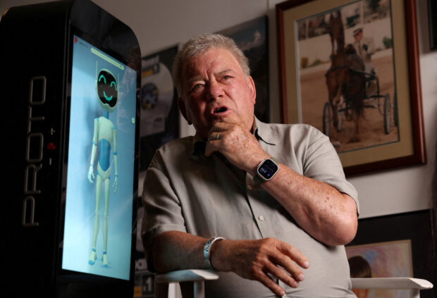 Actor William Shatner interacts and talks with a Proto M AI (Artificial Intelligence) unit at his office in Studio City, California, U.S., August 17, 2023. REUTERS/Mario Anzuoni