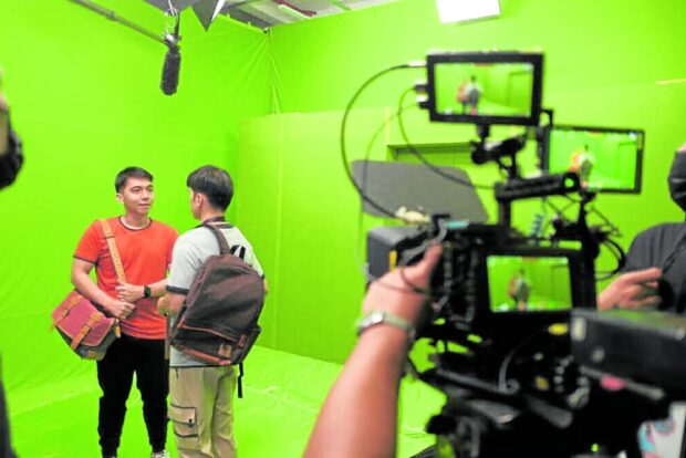 Aquino (right) with Gio Gahol while shooting on green screen