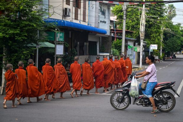 Monks walking on a street in Mandalay.jpg