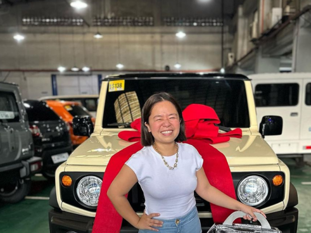 Kiray Celis poses for a photo with her new car.