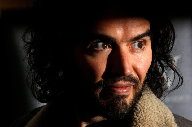 FILE PHOTO: Comedian Russell Brand poses for photographers before signing copies of his new book entitled "Revolution" in central London, December 5, 2014. REUTERS/Suzanne Plunkett