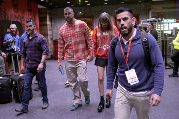 Travis Kelce (center left) and Taylor Swift