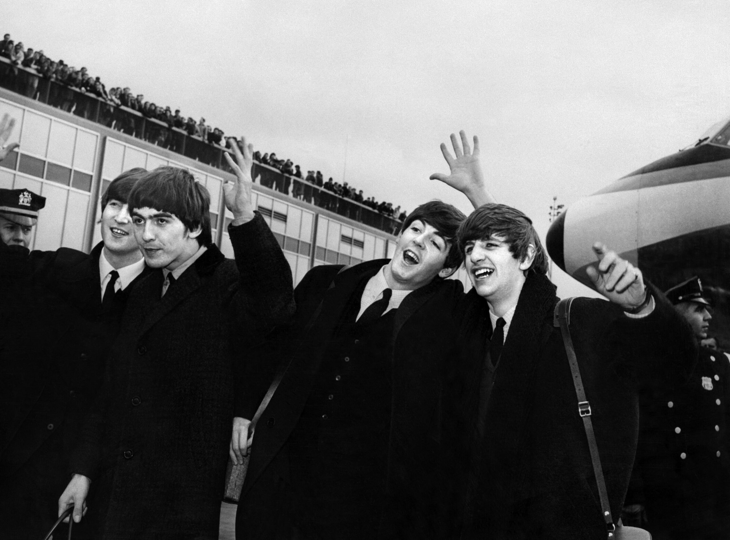 English band the Beatles with, from left to right, John Lennon, Ringo Starr, Paul McCartney and George Harrison, arrive at John F. Kennedy Airport in New York, United States, where they're greeted by a large crowd on February 7, 1964. Beatlemania hit the United States after The Beatles performed on The Ed Sullivan Show in February 09, 1964. A new Beatles song produced with a little help from artificial intelligence and including the vocals of John Lennon will be released on November 2, 2023, more than four decades after it was originally recorded as a demo. "Now And Then", first written and sung by Lennon in 1978, was finished by his fellow band members Paul McCartney and Ringo Starr -- and AI. (Photo by AFP)