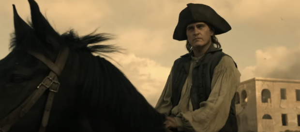 Still a young captain, Napoleon Bonaparte (Joaquin Phoenix) surveys the landscape of Toulon before commanding a successful siege against the British troops. Screenshot from "Napoleon" trailer on YouTube