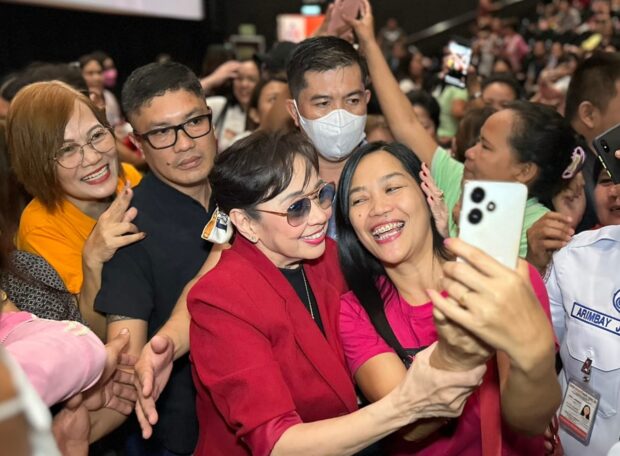 Santos mingles with fans during a theater tour.