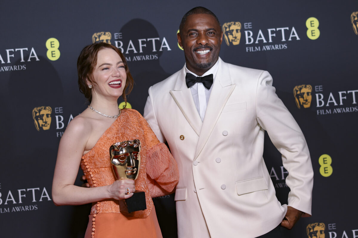 Emma Stone, left, winner of the leading actress award for 'Poor Things', and Idris Elba pose for photographers
