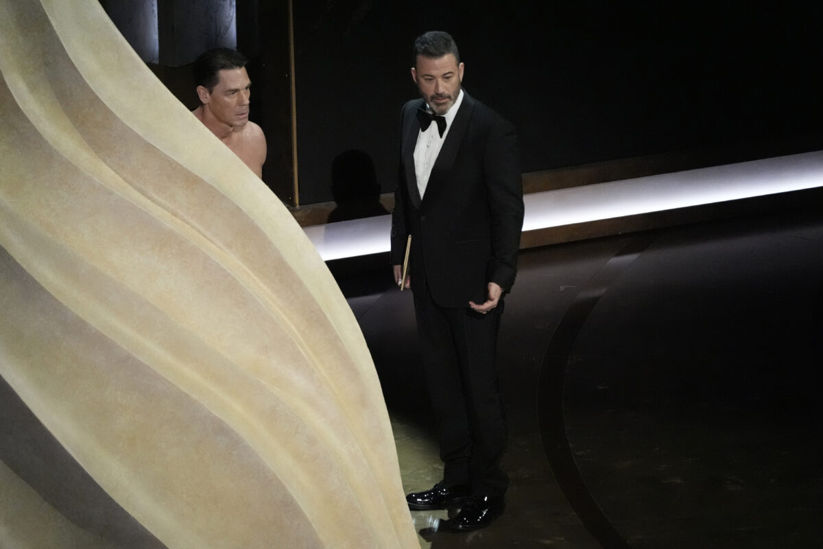 John Cena, left, and Jimmy Kimmel speak during the Oscars on Sunday, March 10, 2024, at the Dolby Theatre in Los Angeles. (AP Photo/Chris Pizzello)