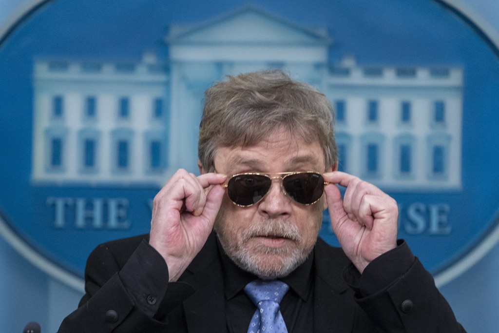'Star Wars' actor Mark Hamill visits 'Joe-bi-Wan Kenobi' in White House  |  Actor Mark Hamill takes off sunglasses given to him by President Joe Biden, as he joins White House press secretary Karine Jean-Pierre as she speaks with reporters in the James Brady Press Briefing Room at the White House, Friday, May 3, 2024, in Washington. (AP Photo/Alex Brandon)