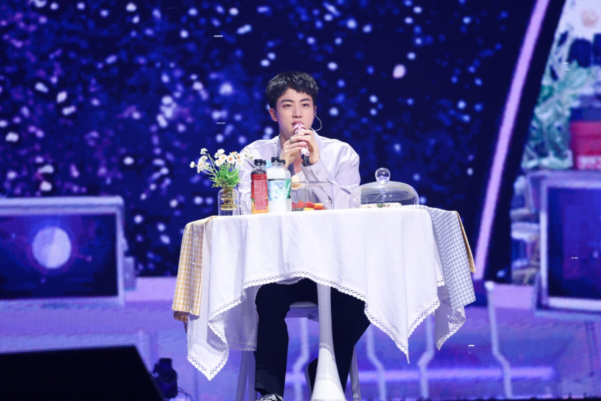 Jin speaks during the mukbang session at his fan-meeting event at Jamsil Arena, Seoul. Image: BigHit Music via The Korea Herald