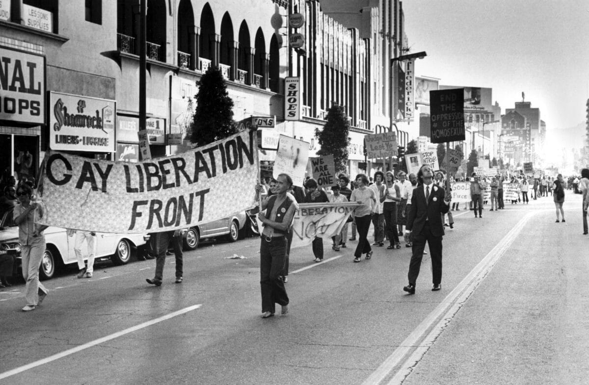 Demonstrators carry signs down Hollywood Boulevard calling to end the discrimination on June 29, 1970, in Hollywood, California