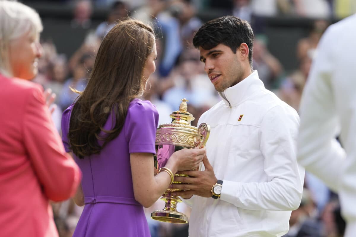 Carlos Alcaraz of Spain receives his trophy from Kate Middleton, Princess of Wales after defeating Novak Djokovic of Serbia in the men's singles final at the Wimbledon tennis championships in London, Sunday, July 14, 2024.