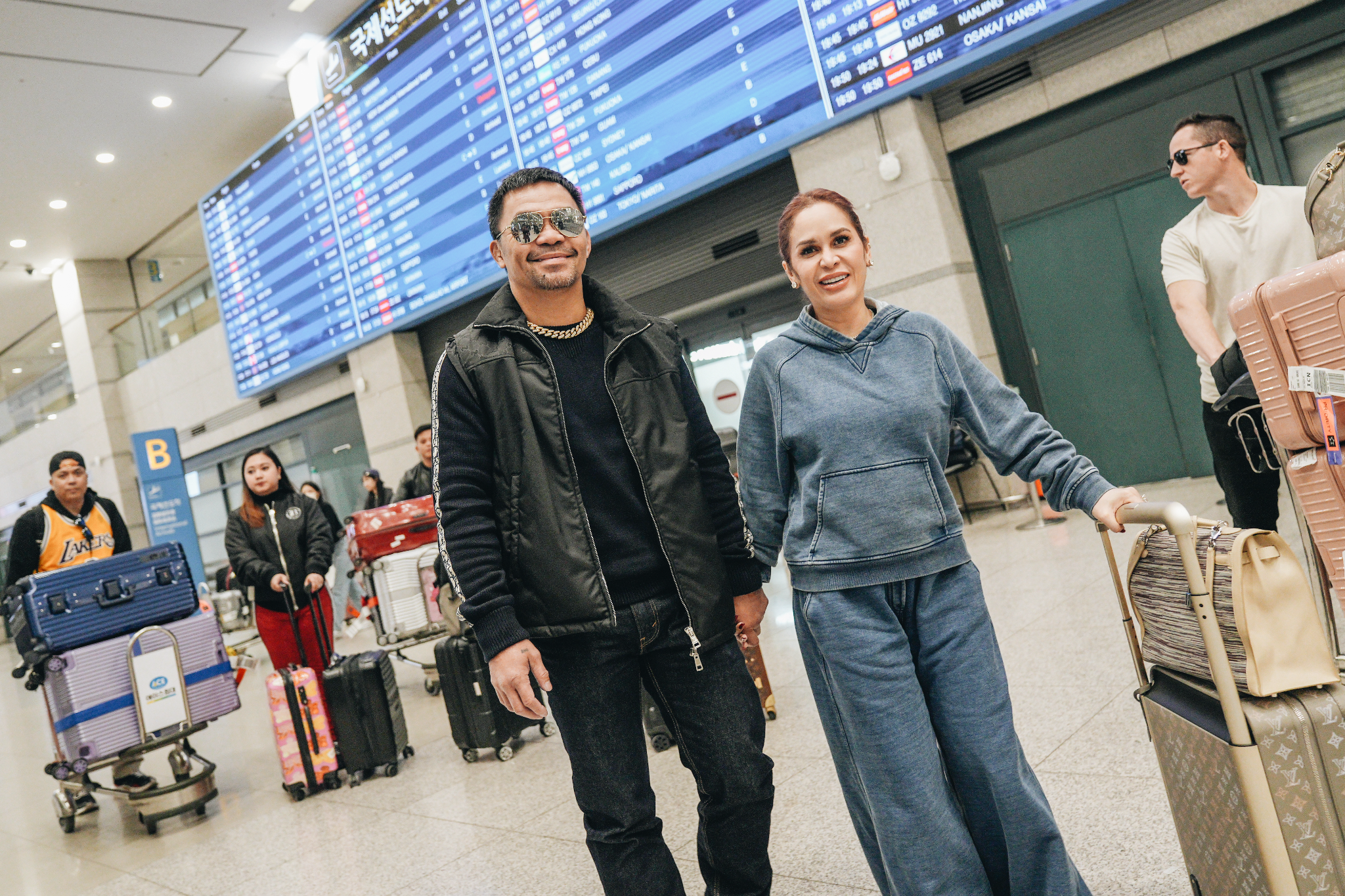 Manny Pacquiao and his wife Jinkee Pacquiao at an airport in South Korea. Image: Courtesy of Netflix 