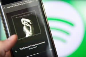 smartphone displaying "The Tortured Poets Department" on Spotify